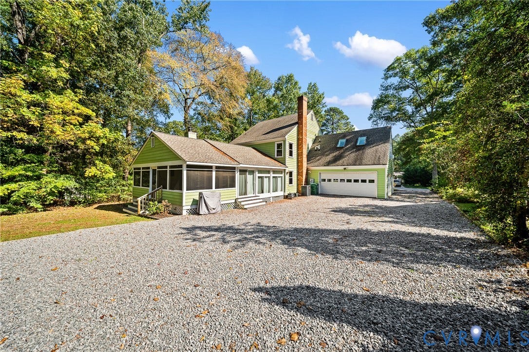 1608 Queens Point Drive, Henrico, VA 23238 Two-story residence featuring light green siding, an attached two-car garage, a brick chimney, and an expansive screened-in porch, all situated on a gravel driveway