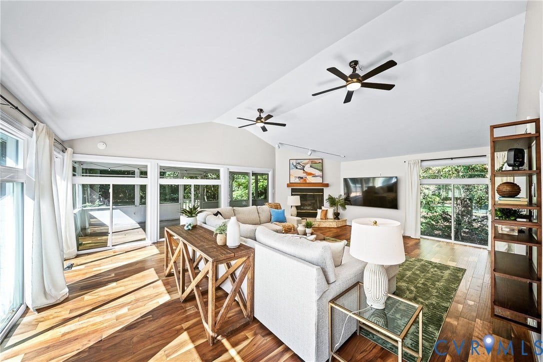 1608 Queens Point Drive, Henrico, VA 23238 Vaulted ceilings, wood-finish flooring, two dual-blade ceiling fans, fireplace with wooden mantel, and multiple sliding glass doors