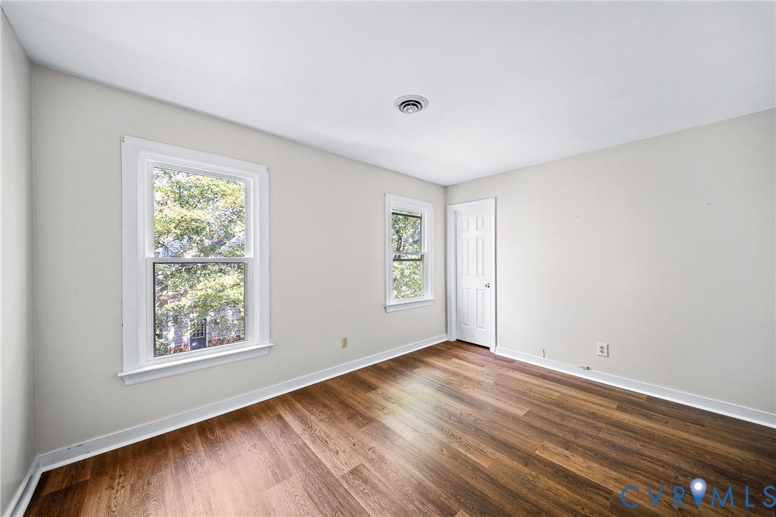 1608 Queens Point Drive, Henrico, VA 23238 Interior room featuring wood-finish flooring, two double-hung windows, and a six-panel interior door