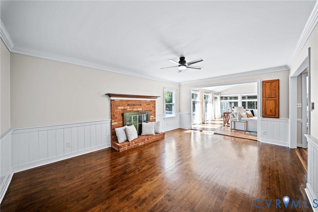 1608 Queens Point Drive, Henrico, VA 23238 Hardwood flooring, brick fireplace with a wood mantel, white wainscoting, and a ceiling fan