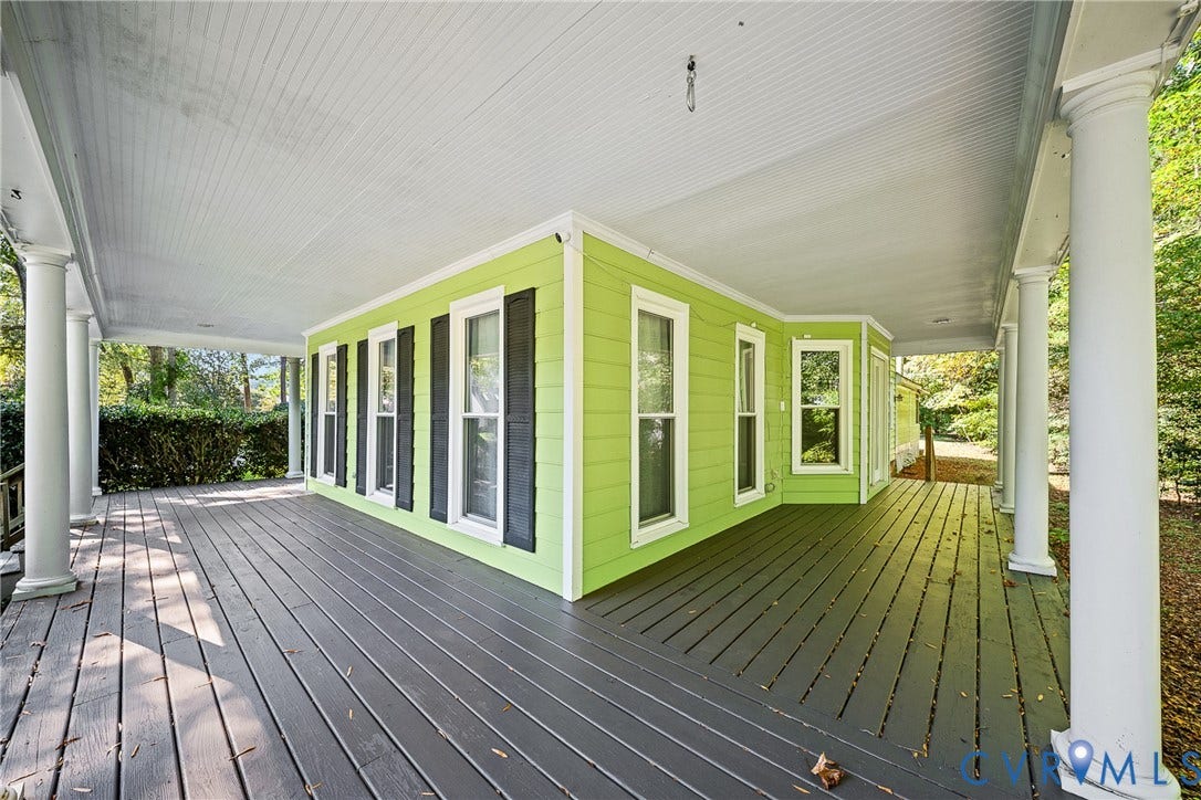 1608 Queens Point Drive, Henrico, VA 23238 Wraparound covered porch featuring painted wood decking, structural columns, horizontal lap siding, and window shutters