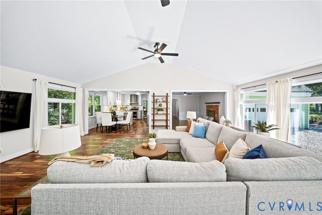 1608 Queens Point Drive, Henrico, VA 23238 Vaulted ceiling with a central blade-style ceiling fan, wood-finish flooring, and expansive windows