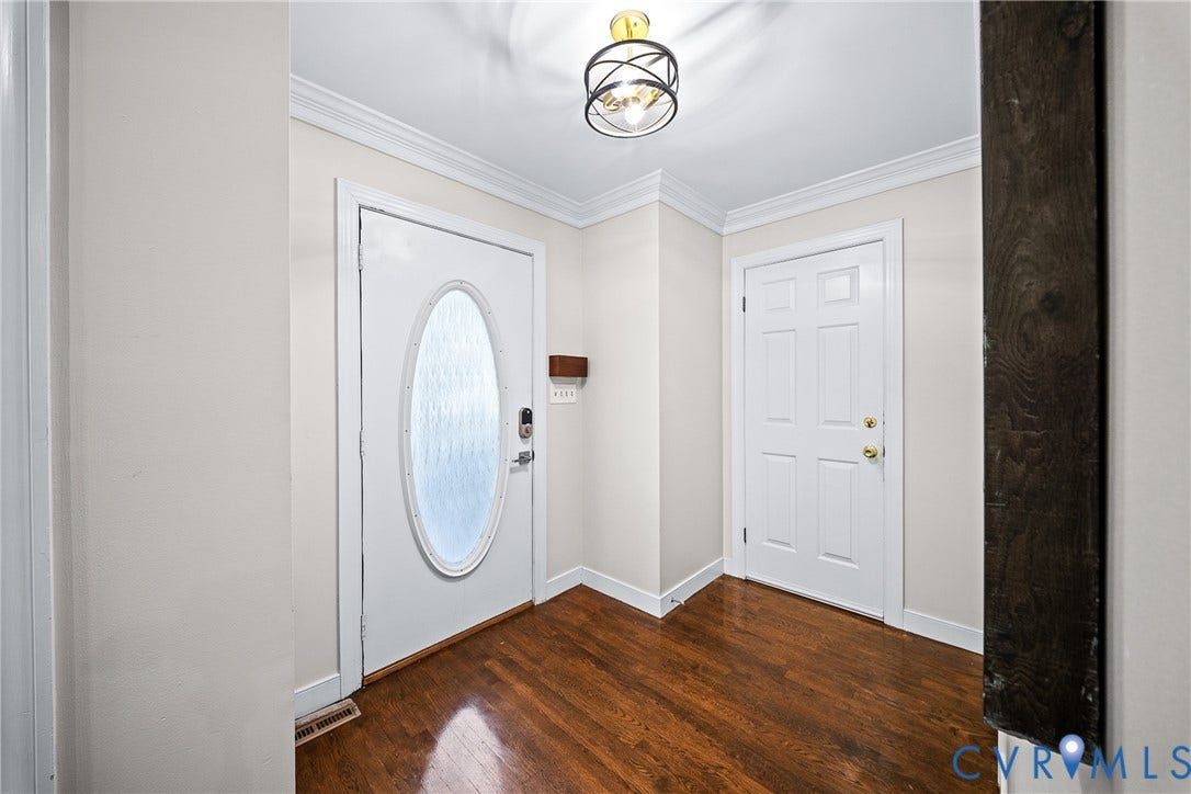 1608 Queens Point Drive, Henrico, VA 23238 Entryway featuring wood-finish flooring, crown molding, a decorative orb chandelier, and a solid-core door with an oval glass insert