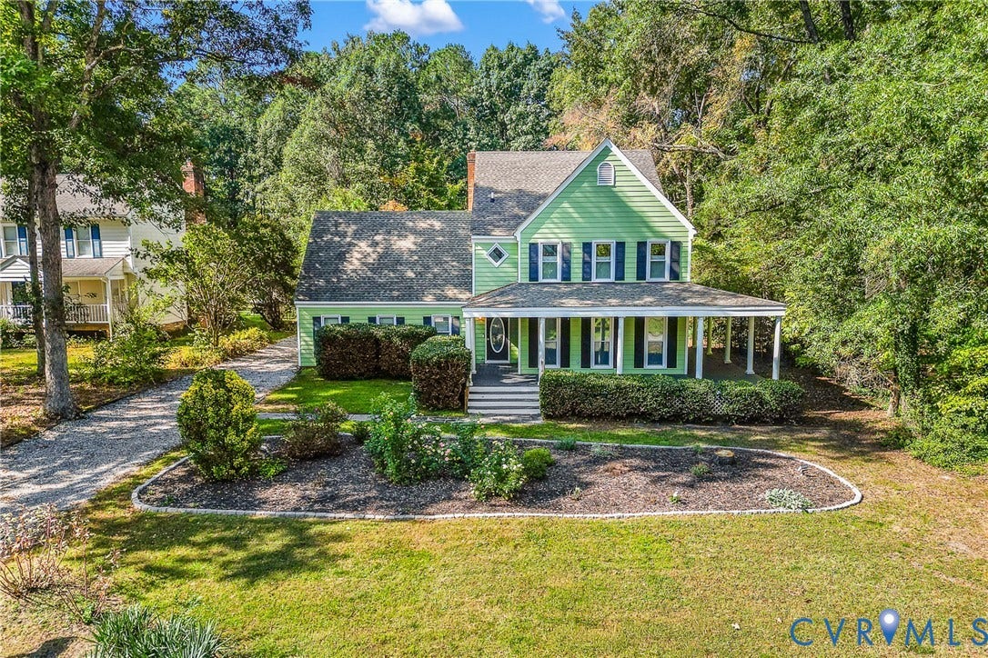1608 Queens Point Drive, Henrico, VA 23238 Two-story home with lap siding, a covered front porch, multi-pane windows, a pitched shingled roof, and stone-edged landscaping beds