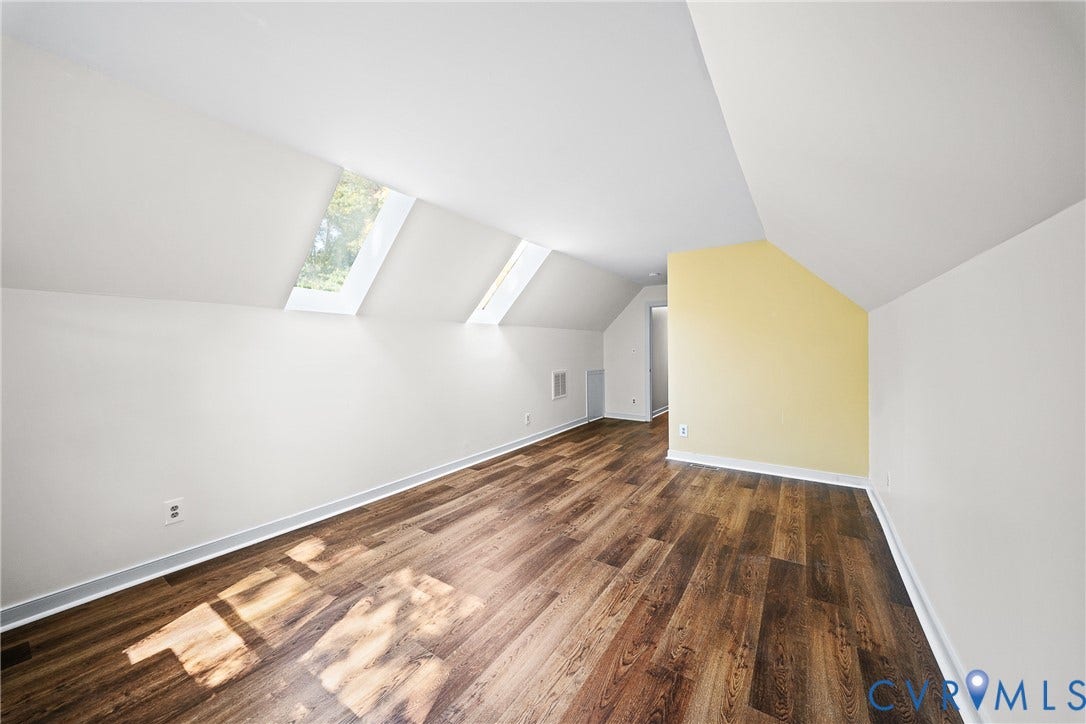 1608 Queens Point Drive, Henrico, VA 23238 Vaulted ceiling featuring two skylights and wood-finish flooring
