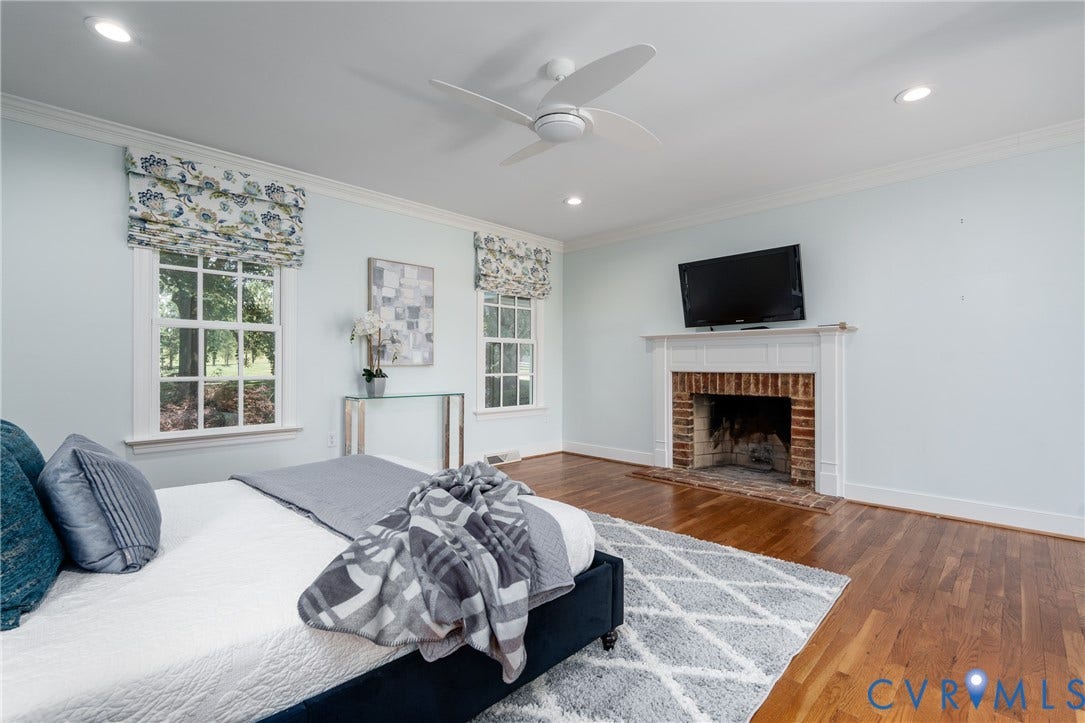 Hardwood flooring, recessed lighting, ceiling fan, brick fireplace, and white window frames