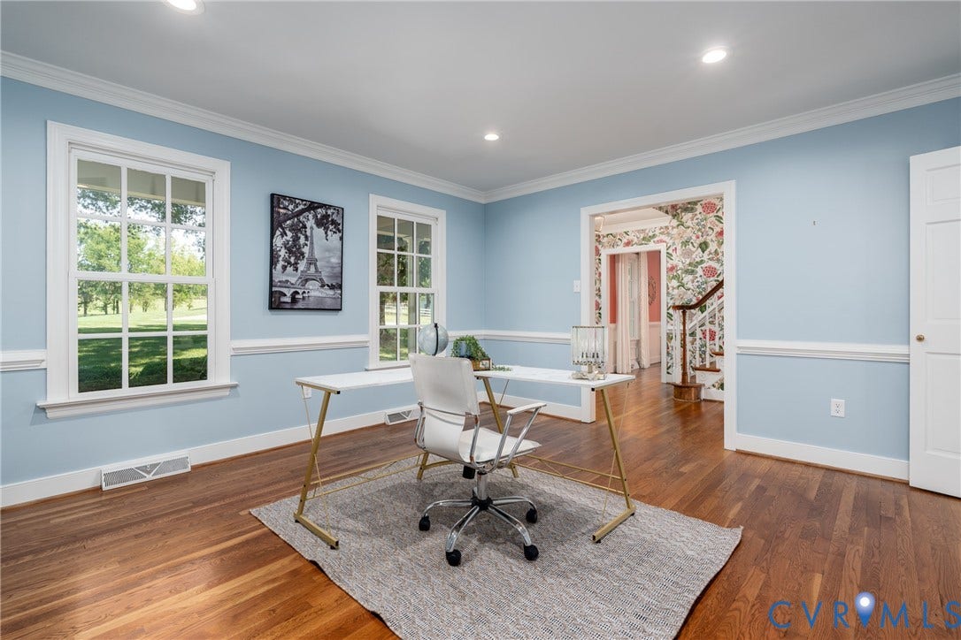 Hardwood flooring, crown molding, chair rail, recessed lighting, and a paneled door