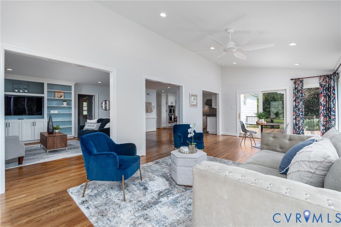 Vaulted ceiling with recessed lighting and ceiling fan, wood-finish flooring, built-in shelving, and sliding glass door