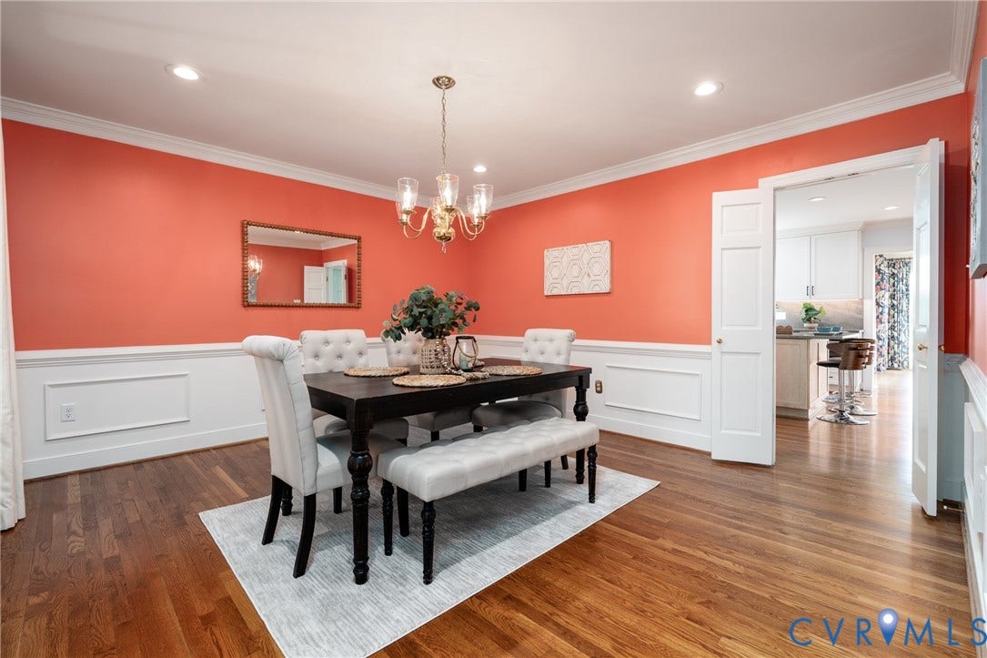 Hardwood flooring, recessed lighting, crown molding, chair rail molding, and a chandelier