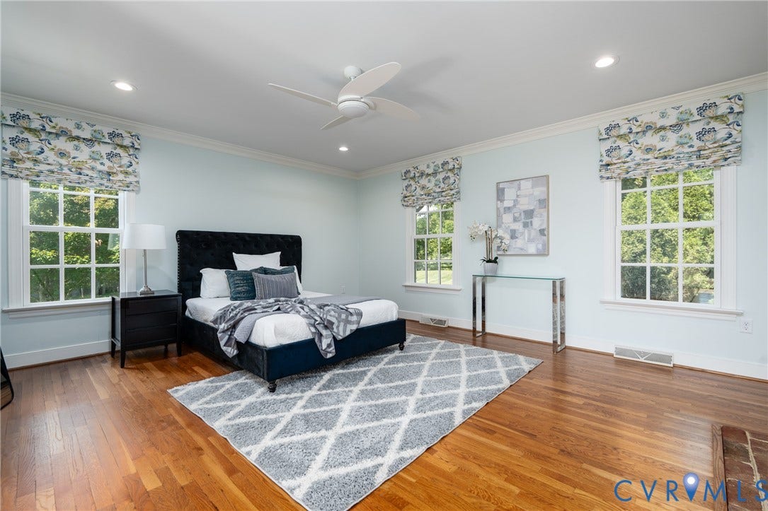 Hardwood flooring throughout, crown molding, white trim, recessed lighting, and a ceiling fan