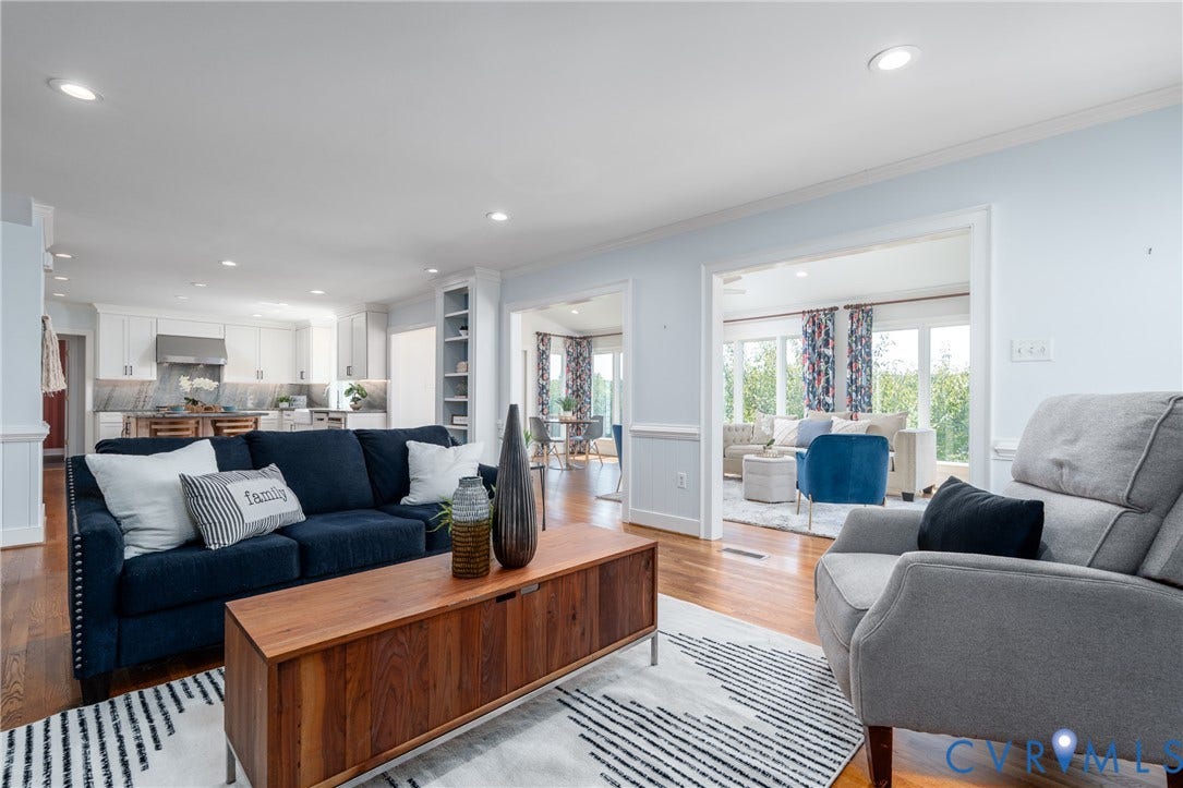 Hardwood-finish flooring, recessed lighting, white built-in shelving, and light-colored walls