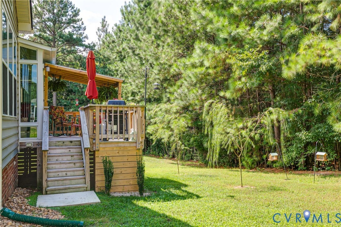 Wood Deck Leading to Lush Backyard.