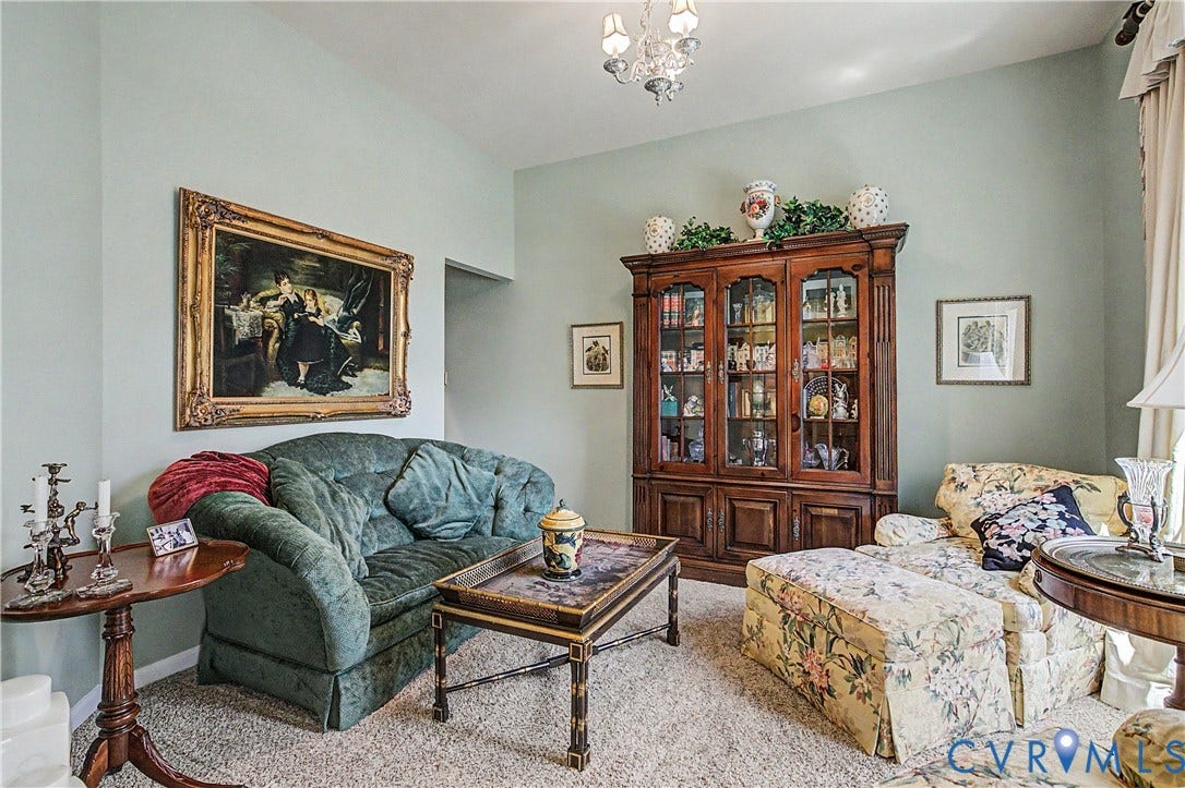 Living Room Featuring Carpet and Crystal Light Fixture.
