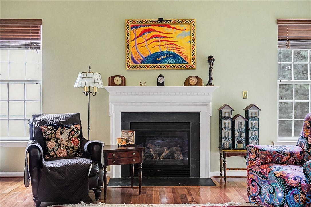 Gas Fireplace Featuring Custom White Mantel and Black Surround.