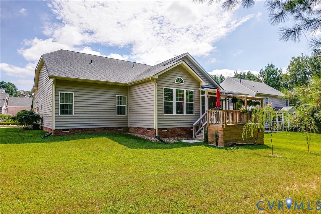 Exterior View of Spacious Backyard and Deck Area.