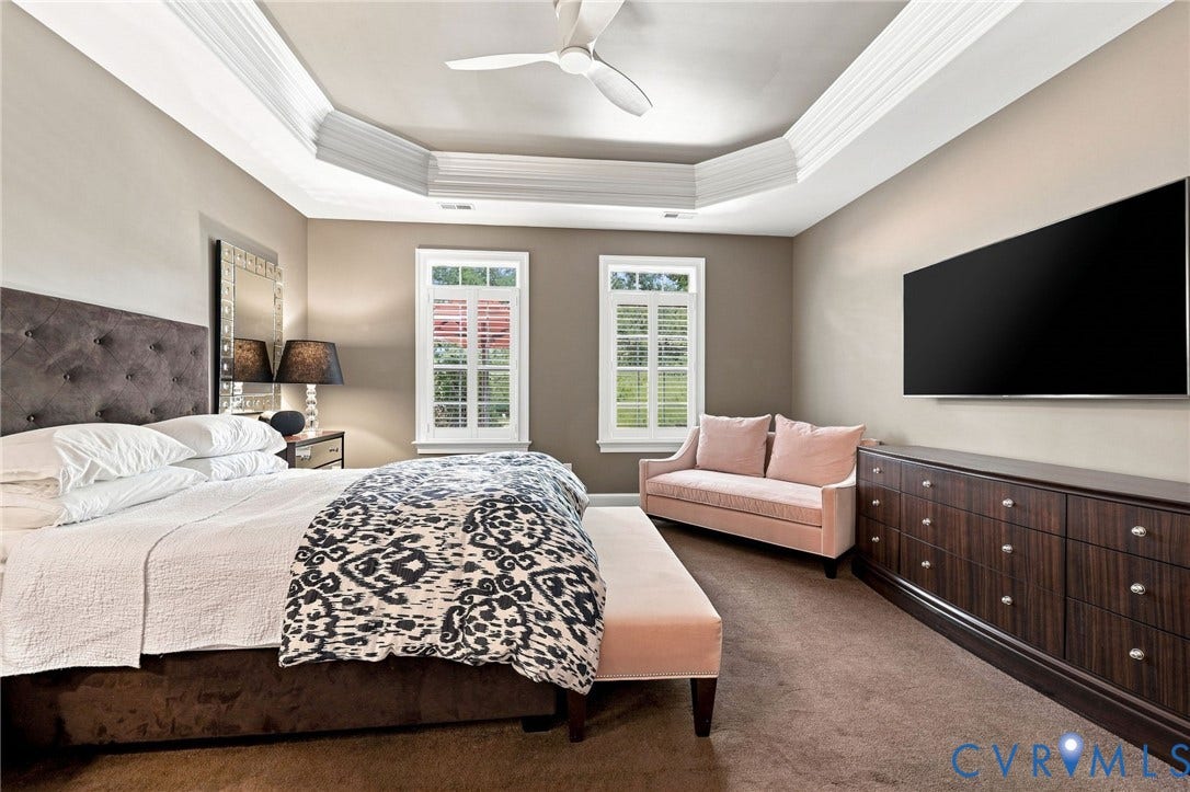 11762 Triple Notch Terrace, Three Notch Place, Henrico, VA 23233 Tray ceiling with crown molding, ceiling fan, two windows with plantation shutters, wall-mounted television, and wood-finish dresser