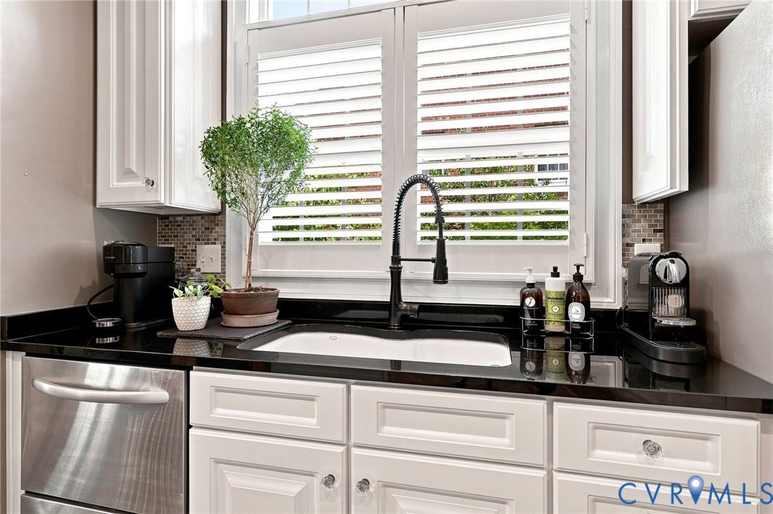 11762 Triple Notch Terrace, Three Notch Place, Henrico, VA 23233 White cabinetry with crystal knobs, dark countertops, tile backsplash, stainless steel dishwasher, and a window with plantation shutters