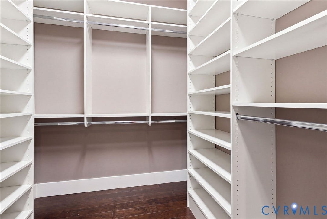 11762 Triple Notch Terrace, Three Notch Place, Henrico, VA 23233 Built-in closet system featuring white shelving, multiple hanging rods, and dark wood-finish flooring