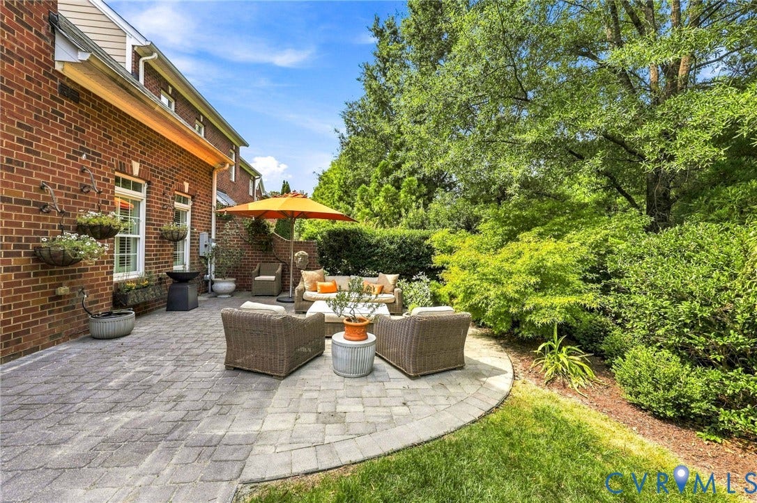 11762 Triple Notch Terrace, Three Notch Place, Henrico, VA 23233 Garden patio living with brick exterior, huge extended stone paver patio, lush landscaping, brick side privacy wall, and gas plumbed for outdoor grill or firepit.
