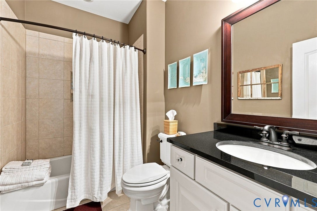 11762 Triple Notch Terrace, Three Notch Place, Henrico, VA 23233 Bathroom featuring a tub/shower with tiled surround, granite top sink, and framed mirror