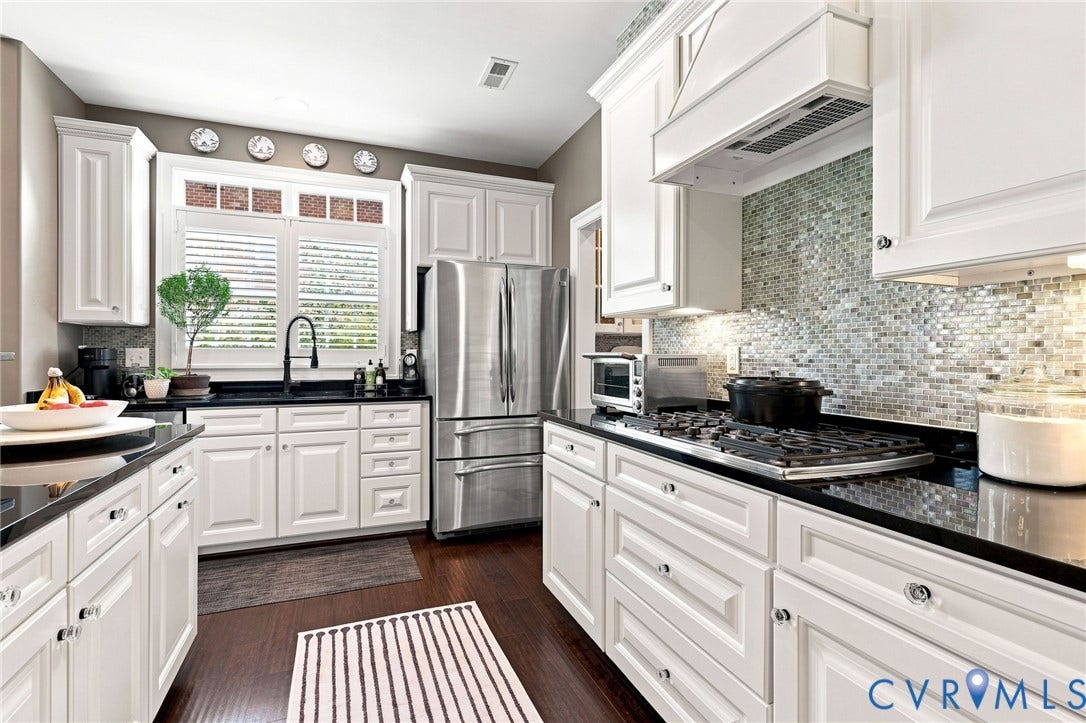 11762 Triple Notch Terrace, Three Notch Place, Henrico, VA 23233 White cabinetry with dark contrasting countertops, a stainless steel French door refrigerator, and a gas range with a dedicated vent hood