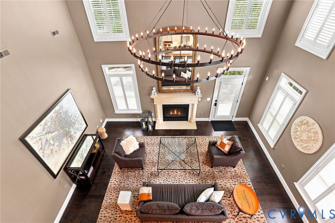 11762 Triple Notch Terrace, Three Notch Place, Henrico, VA 23233 Two-story living area featuring a large chandelier, wood-finish flooring, a fireplace with a mantel, multiple windows, and a glass-paneled door