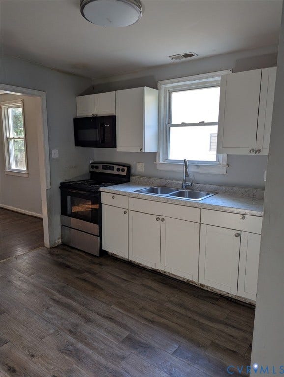 2218 Concord Avenue, Richmond, VA 23234 Kitchen featuring wood-finish flooring, white cabinetry, double basin sink, and a built-in microwave