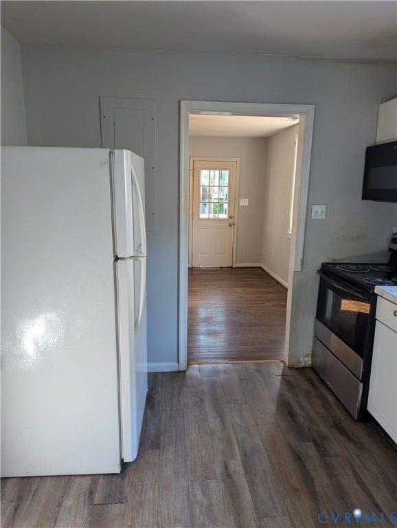 2218 Concord Avenue, Richmond, VA 23234 Wood-finish flooring with a white refrigerator and black over-the-range microwave