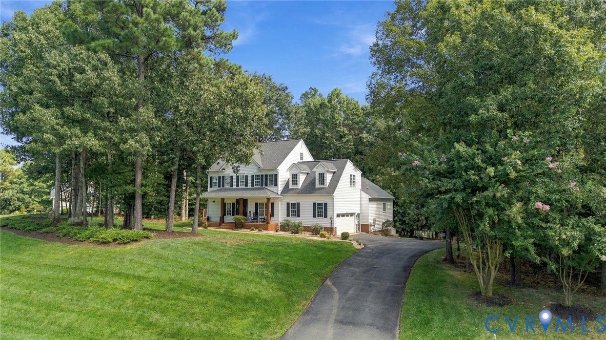 8301 Macandrew Terrace, Chesterfield, VA 23838 White two-story residence with dormer windows, a covered front porch, and a paved driveway
