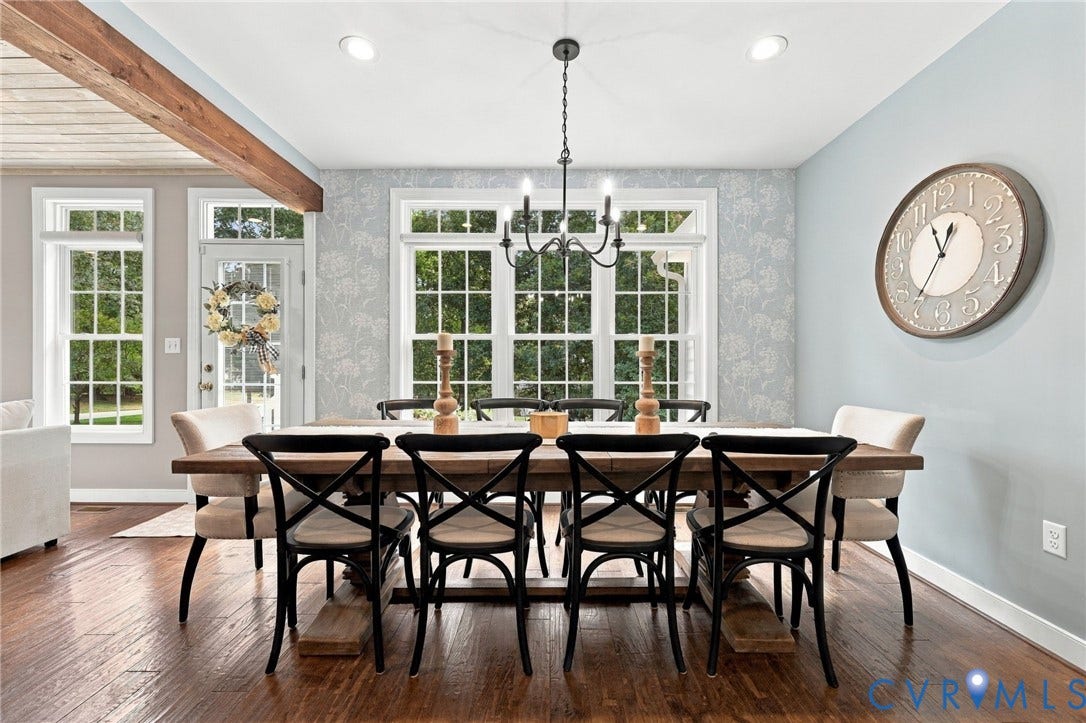 8301 Macandrew Terrace, Chesterfield, VA 23838 Elegant dining space anchored by a black rectangular table with coordinating X-back chairs, illuminated by a vintage-inspired pendant fixture
