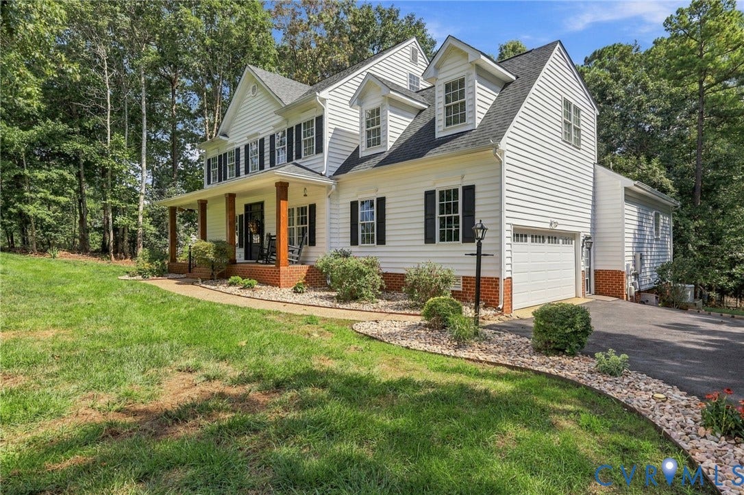 8301 Macandrew Terrace, Chesterfield, VA 23838 Classic white siding exterior with a covered front porch featuring wood columns, a two-car garage, and dormer windows