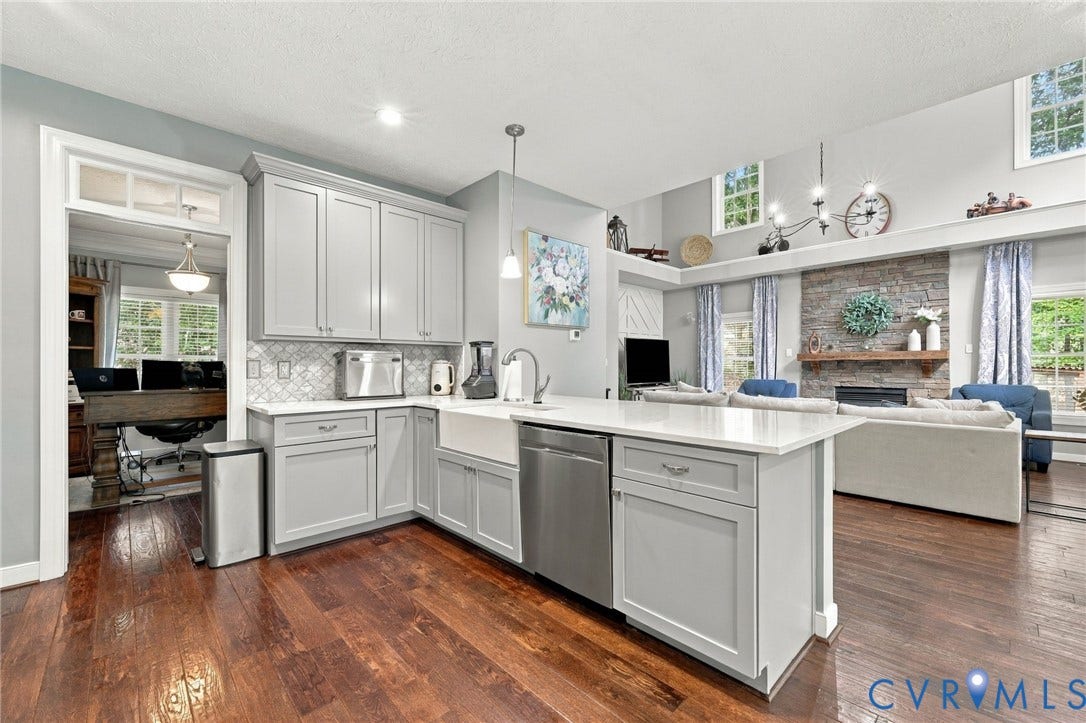 8301 Macandrew Terrace, Chesterfield, VA 23838 Hardwood flooring throughout, kitchen featuring light gray cabinetry, white countertops, an apron-front sink, and stainless steel appliances