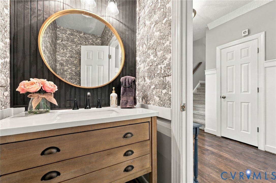 8301 Macandrew Terrace, Chesterfield, VA 23838 Vanity with a wood-finish base, integrated white sink, and dark bronze hardware