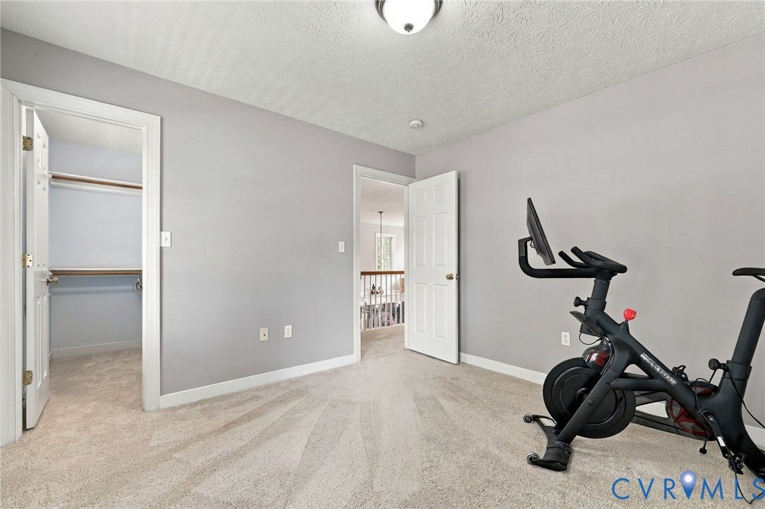 8301 Macandrew Terrace, Chesterfield, VA 23838 Neutral-toned walls, plush carpeting, and a built-in closet with shelving and hanging rods