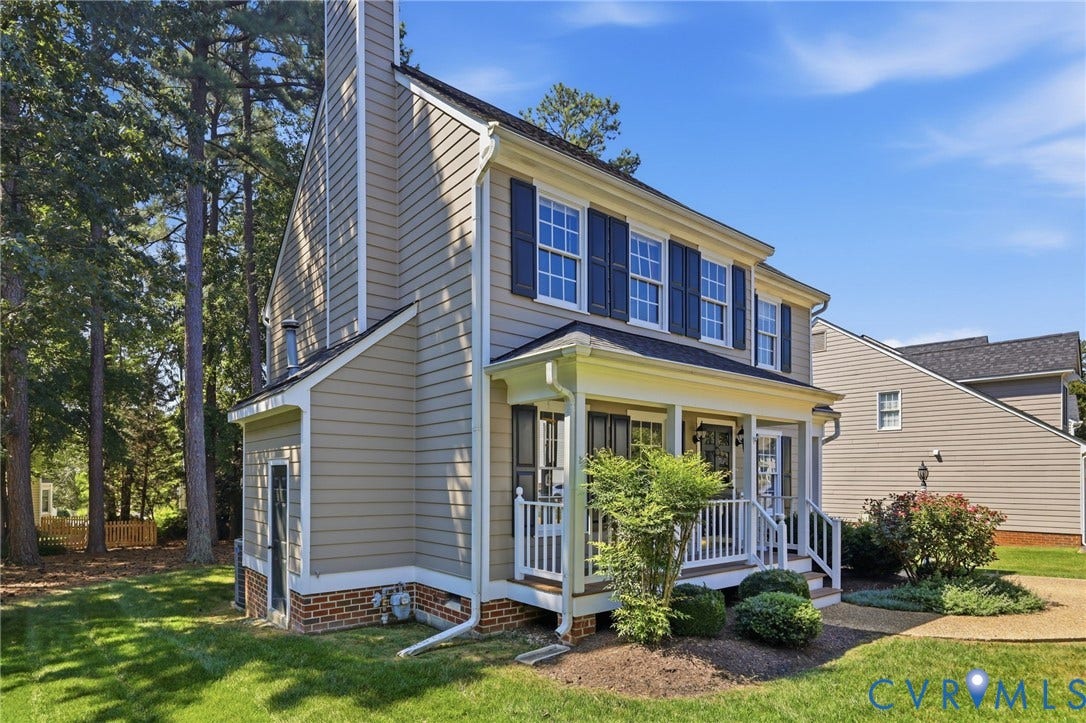 12309 Maybrook Lane, Wyndham, Glen Allen, VA 23059 Two-story residence featuring light-toned siding, dark shutters, a covered front porch, and a prominent chimney