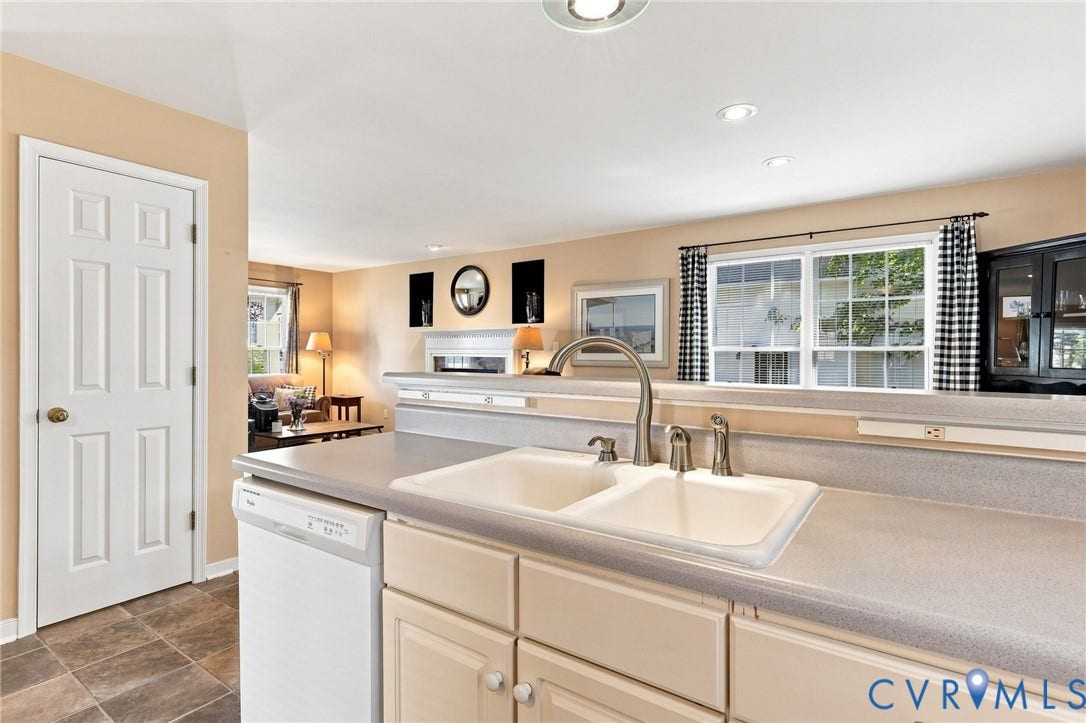 12309 Maybrook Lane, Wyndham, Glen Allen, VA 23059 Kitchen featuring a double basin sink with a gooseneck faucet, light-toned cabinetry, and integrated dishwasher