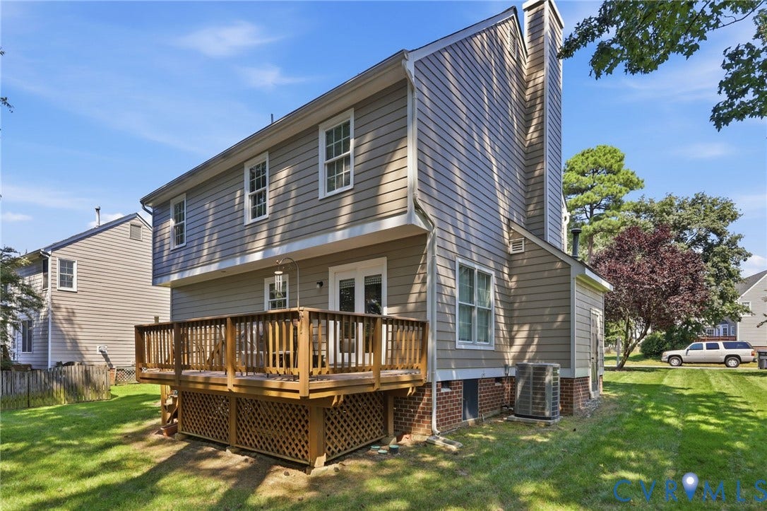 12309 Maybrook Lane, Wyndham, Glen Allen, VA 23059 Exterior featuring light brown siding, a multi-level wood deck, white-framed windows, and a prominent chimney structure