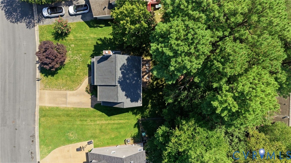 12309 Maybrook Lane, Wyndham, Glen Allen, VA 23059 Paved driveway leading to a residence with a gray shingle roof, surrounded by mature trees and a green lawn