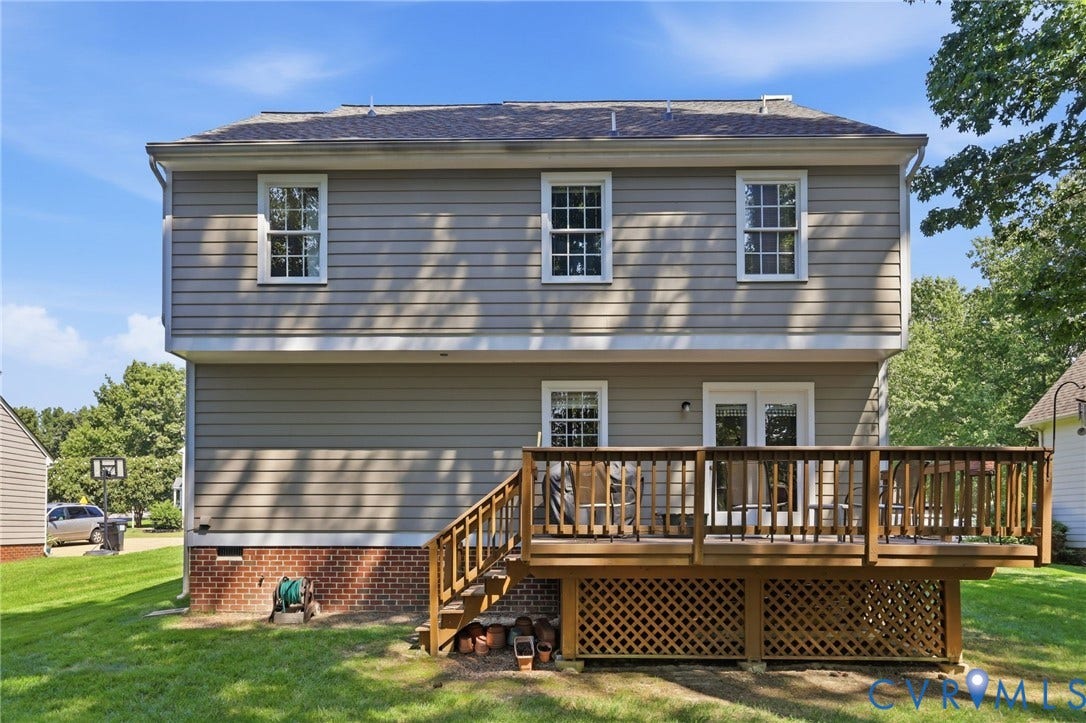 12309 Maybrook Lane, Wyndham, Glen Allen, VA 23059 Two-story residential structure with horizontal siding, a gabled roof, and a wood deck featuring lattice skirting