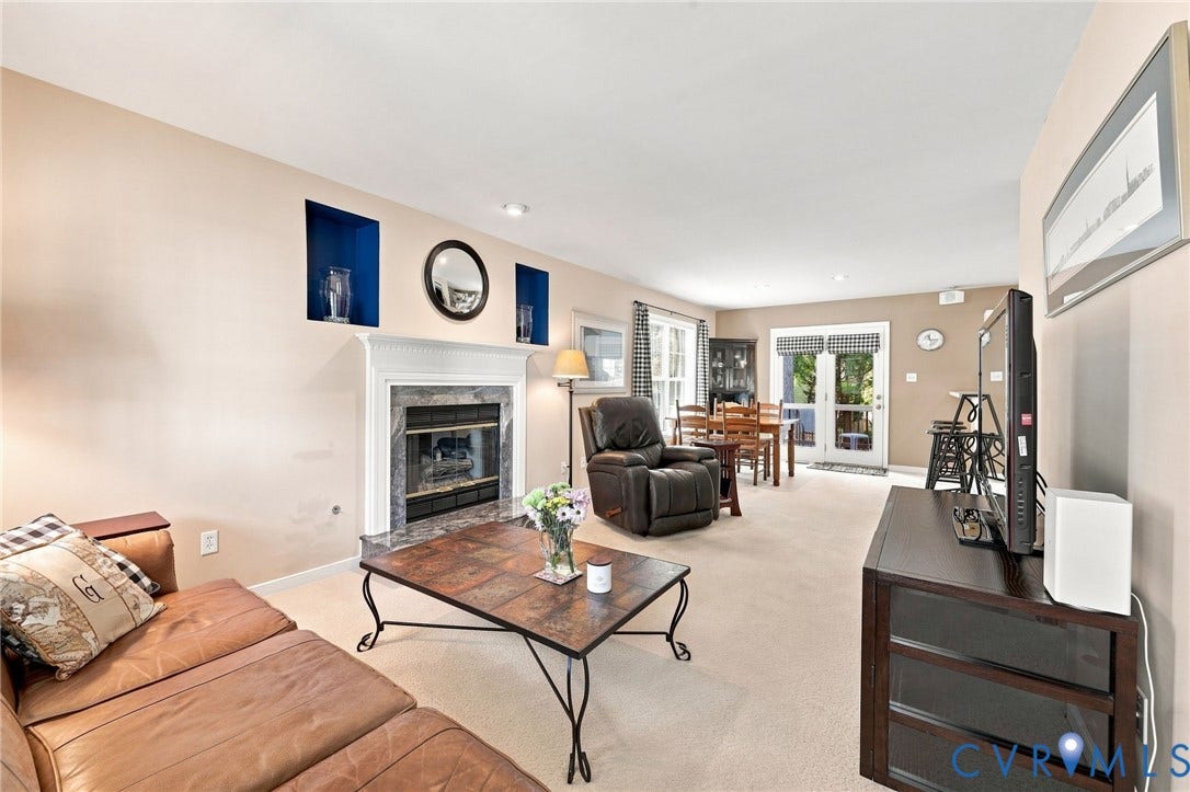 12309 Maybrook Lane, Wyndham, Glen Allen, VA 23059 Living area with a fireplace featuring a stone surround and a white mantel