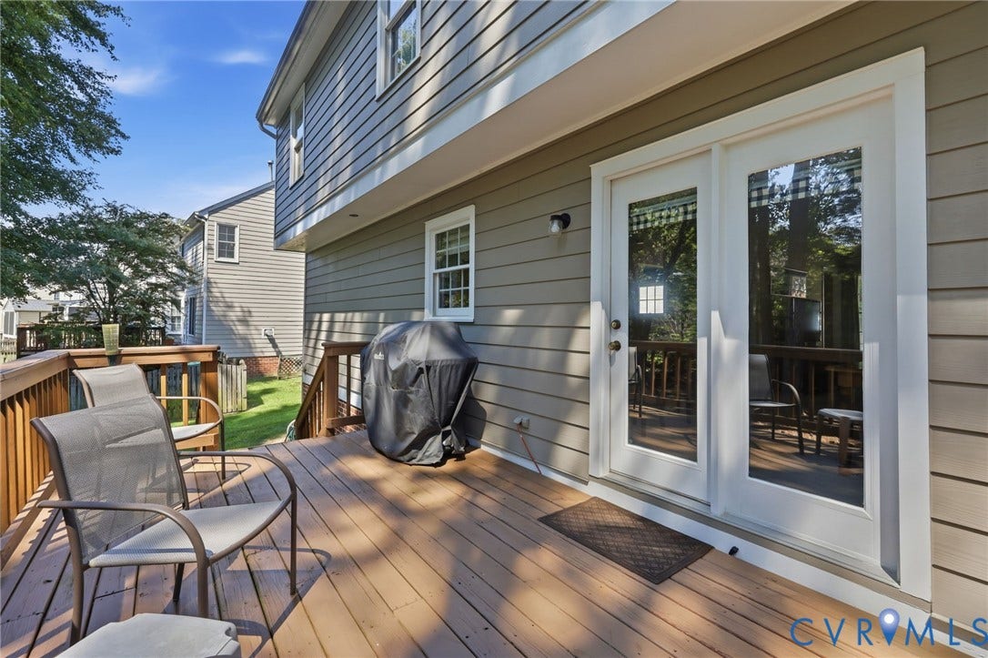 12309 Maybrook Lane, Wyndham, Glen Allen, VA 23059 Expansive wood-finish deck with wood railings, featuring white-framed double doors and siding exterior