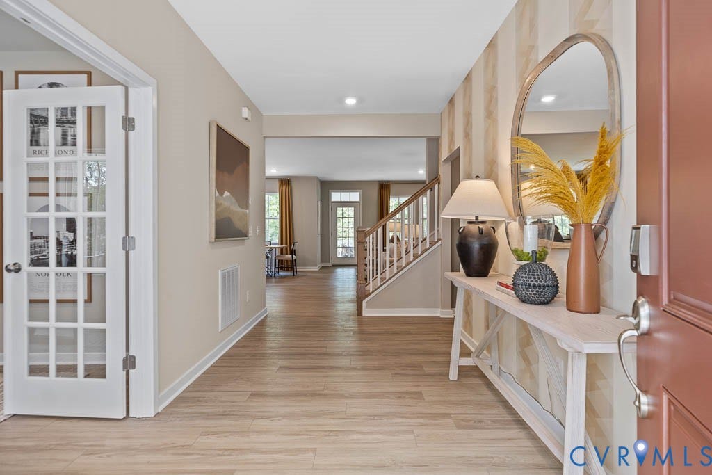 16056 Greenhart Drive, Chesterfield, VA 23832 Inviting entryway featuring wood-finish flooring, a contemporary staircase with wood newel posts, and a French-door style room entrance