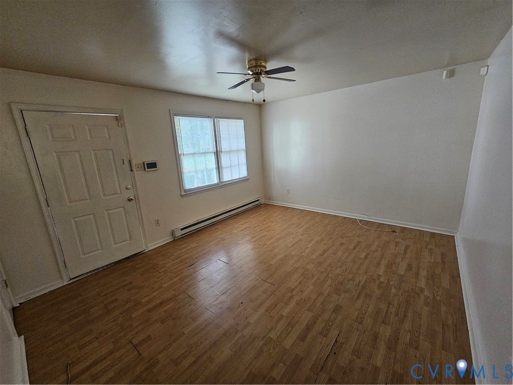 3020 Groveland Avenue, Richmond, VA 23222 Wood-finish flooring, white paneled door, two-pane window, and ceiling fan with integrated lighting