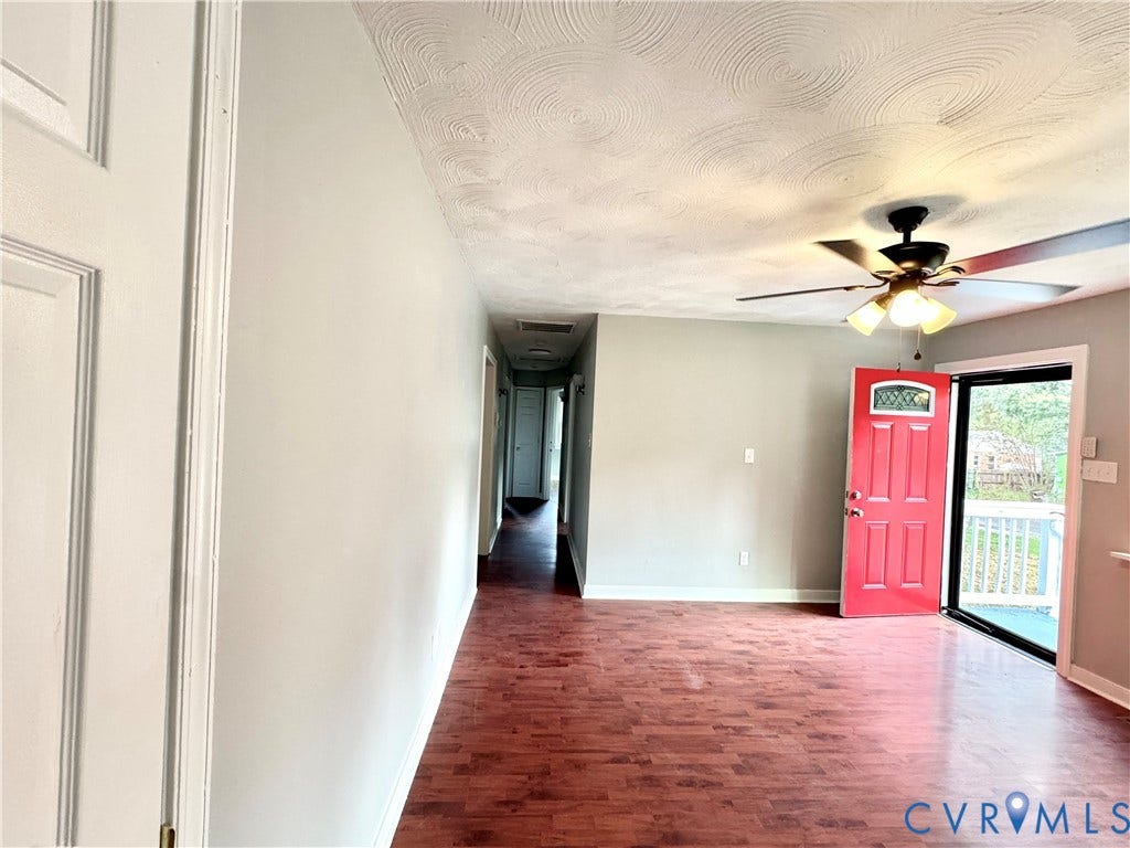 2711 Cheatham Street, Henderson & Johnson, Richmond, VA 23234 Wood-finish flooring, a textured ceiling, and a ceiling fan with integrated lighting
