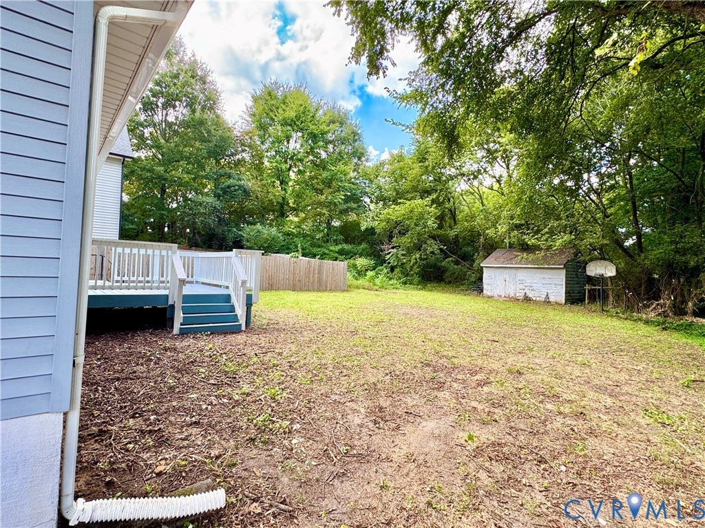 2711 Cheatham Street, Henderson & Johnson, Richmond, VA 23234 Wood deck with white railing, privacy fencing, and mature trees