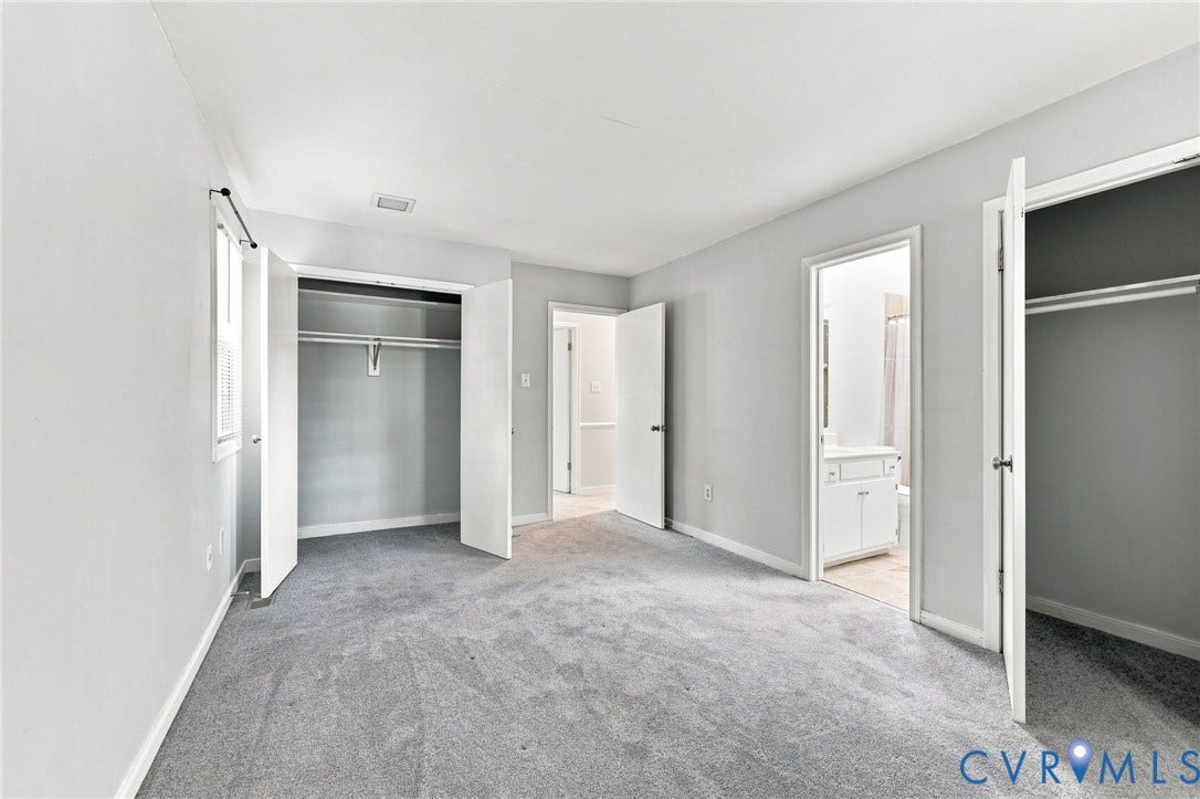 608 Dauphin Drive, Chesterfield, VA 23236 Carpeted room with light gray walls, a window, and two closets