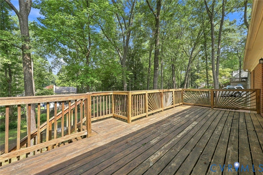 608 Dauphin Drive, Chesterfield, VA 23236 Expansive wood deck with a decorative sunburst railing design and a staircase