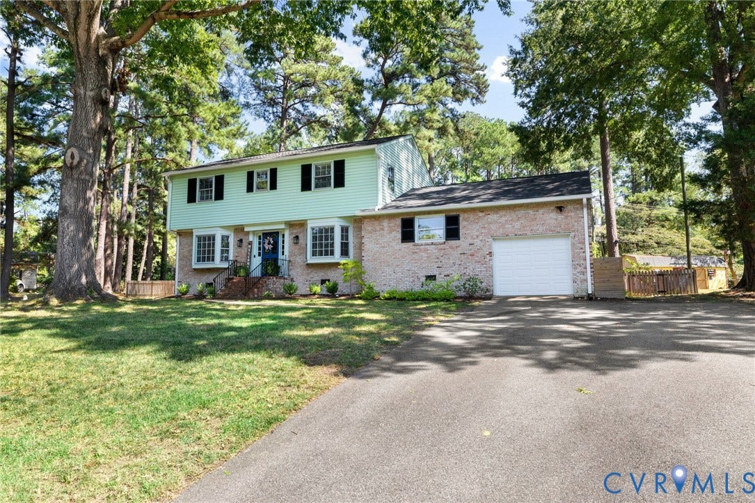 1109 Swissvale Place, Henrico, VA 23229 Brick and siding exterior with multiple bay windows, black window shutters, and a front entry door with sidelights