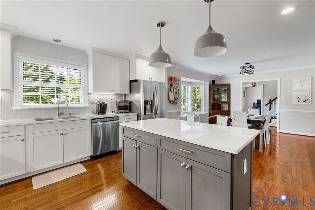 1109 Swissvale Place, Henrico, VA 23229 Kitchen featuring an island with quartz countertops, stainless steel appliances, pendant lighting, and hardwood flooring