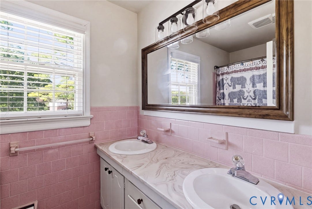 1109 Swissvale Place, Henrico, VA 23229 Dual vanity, a patterned countertop, and a wood-framed mirror